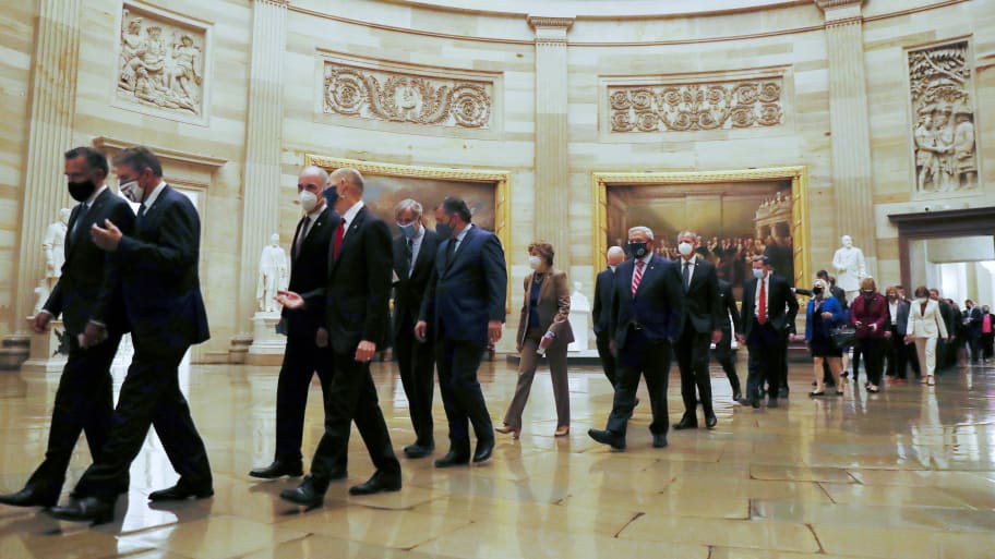 Senators walk through the Rotunda from the Senate Chamber to the House Chamber