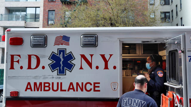 A FDNY ambulance sits with a door open.