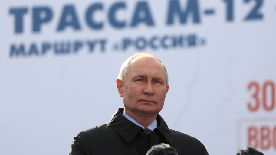 Russian President Vladimir Putin before a podium at a ceremony