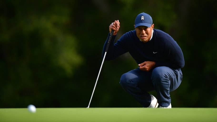 Feb 16, 2023; Pacific Palisades, California, USA; Tiger Woods lines his putt on the twelfth green during the first round of The Genesis Invitational golf tournament. 