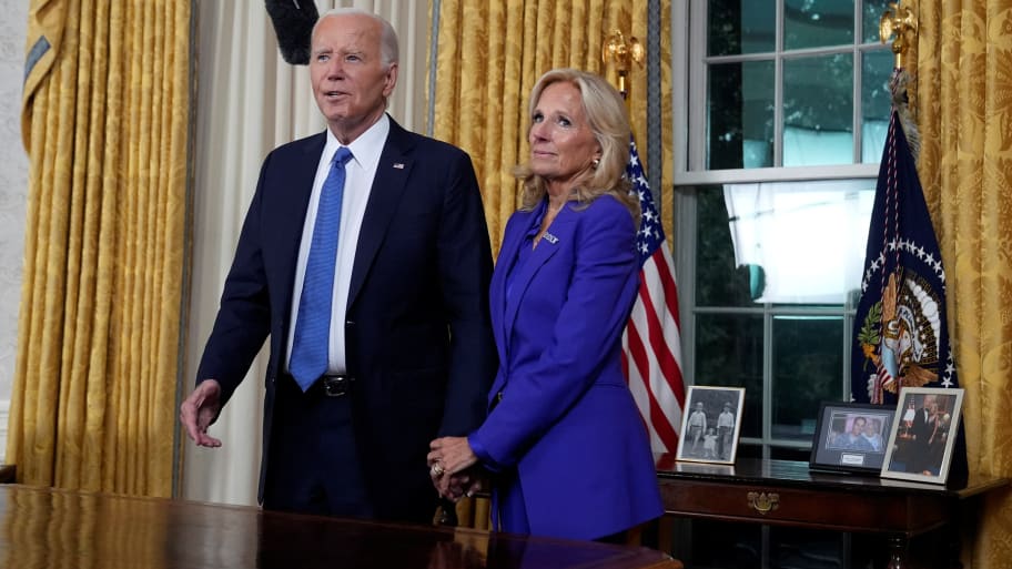 U.S. President Joe Biden stands with first lady Jill Biden after addressing the nation from the Oval Office