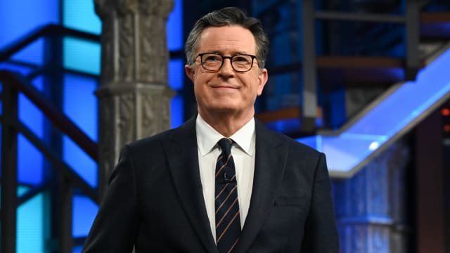 Stephen Colbert smiles on the set of "The Late Show"