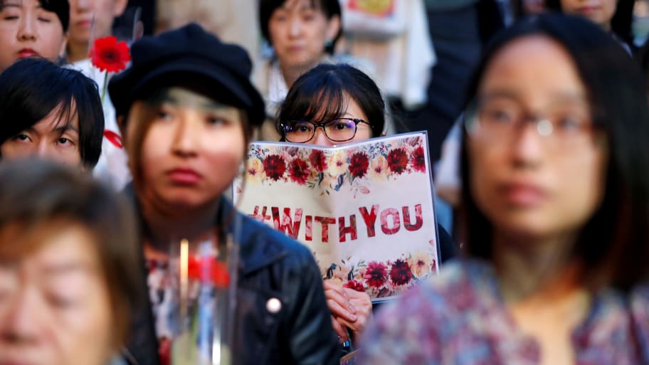 Protesters gather at the rally called 'Flower Demo' to criticize recent acquittals in court cases of alleged rape in Japan and call for revision of the anti-sex crime law, in front of Tokyo Station in Tokyo, Japan June 11, 2019.
