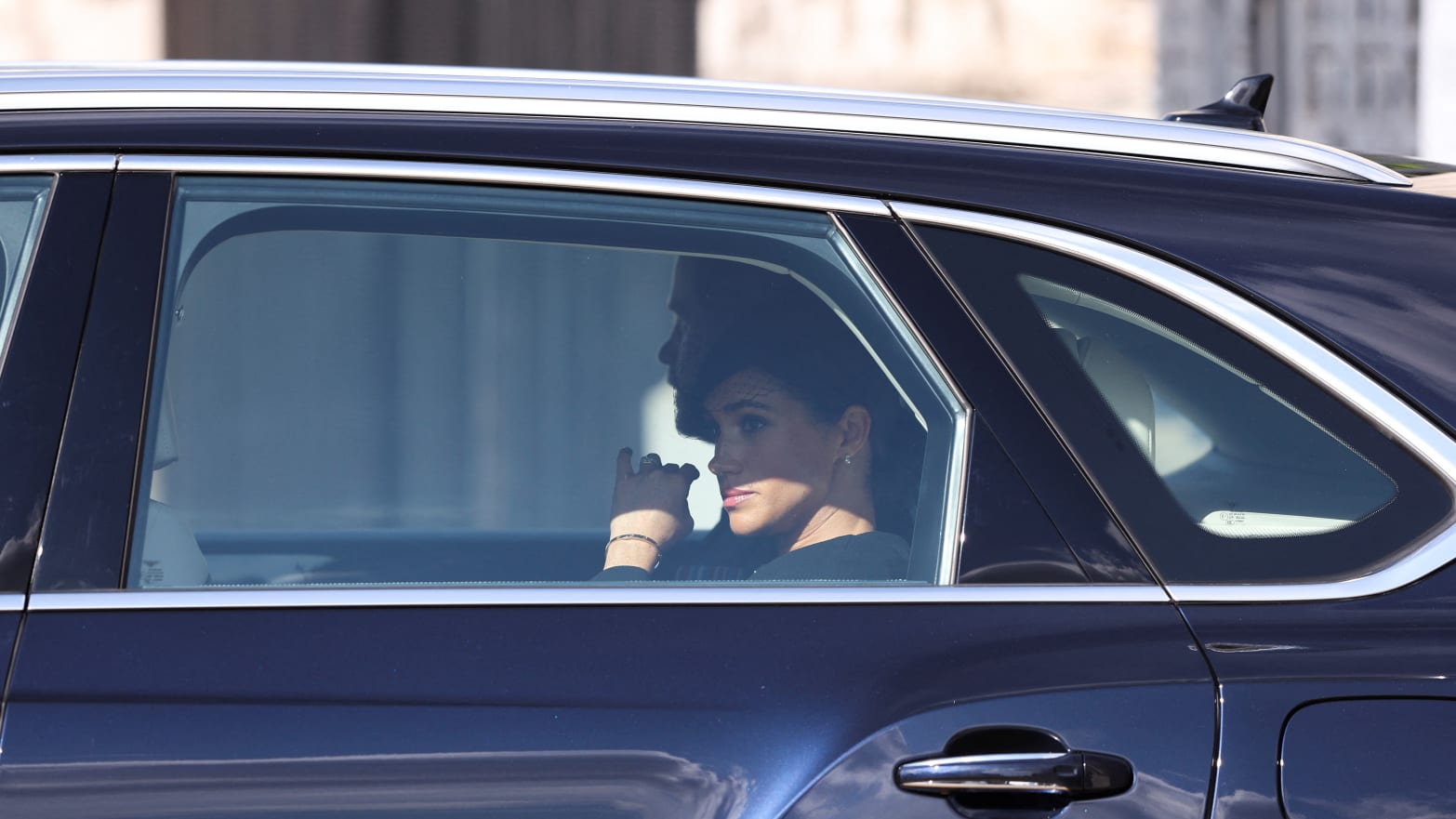 Prince Harry, Duke of Sussex and Meghan, Duchess of Sussex depart in a car after the procession for the Lying-in State of Queen Elizabeth II on September 14, 2022.