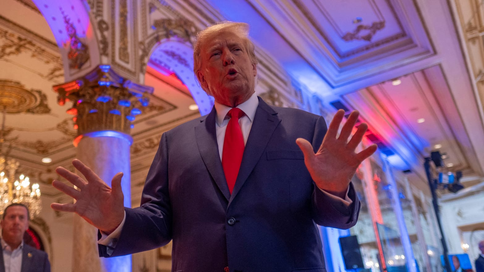 Donald Trump has his hands up while speaking inside Mar-a-Lago.