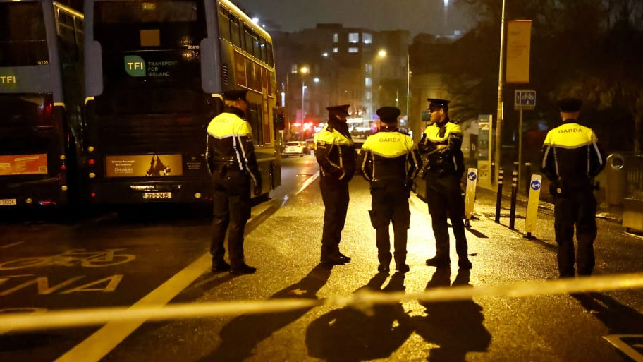 Police officers stand guard near the scene of a suspected stabbing that left children injured in Dublin, Ireland.