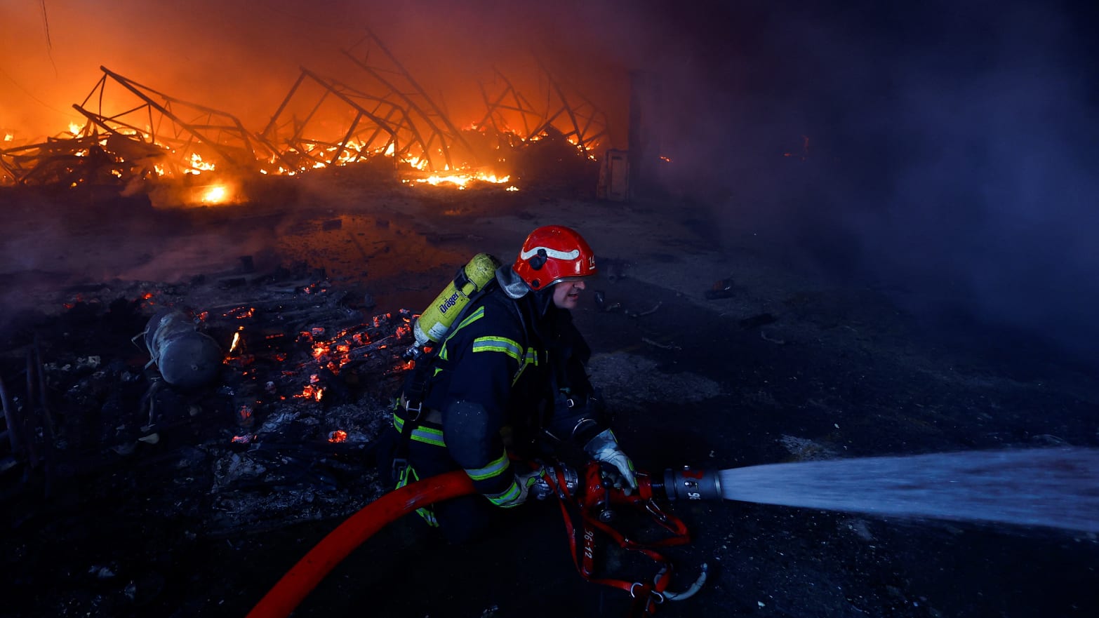 A firefighter works at a site of a warehouse heavily damaged during a Russian missile strike, amid Russia’s attack on Ukraine, in Kyiv, Ukraine December 29, 2023. 