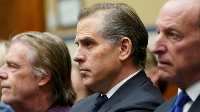 Hunter Biden, wearing a suit and tie, sits during a court hearing.