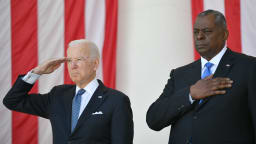 US President Joe Biden(L) salutes along with Secretary of Defense Lloyd Austin before at Arlington National Cemetery on Memorial Day in Arlington, Virginia on May 31, 2021.