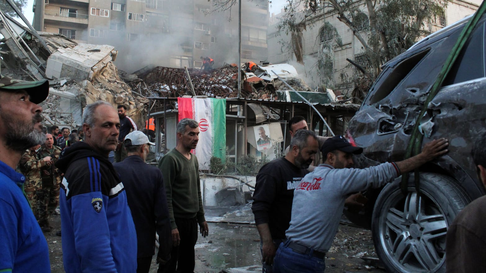 Rescue workers move near the scene of an airstrike in Damascus, Syria.