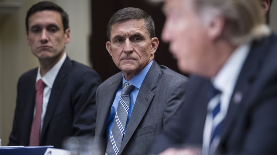 National Security Adviser Mike Flynn listens to President Trump during a listening session with cyber security experts in the Roosevelt Room the White House.