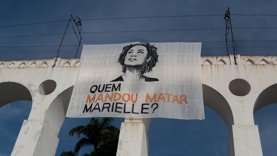 “Who commissioned the murder of Marielle?” says a poster at a rally one year after the murder of prominent city councilor Marielle Franco.