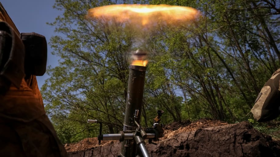Ukrainian service members from a 28th separate mechanised brigade fire a mortar at their positions at a front line near the city of Bakhmut in Donetsk region, Ukraine, May 18, 2023. 