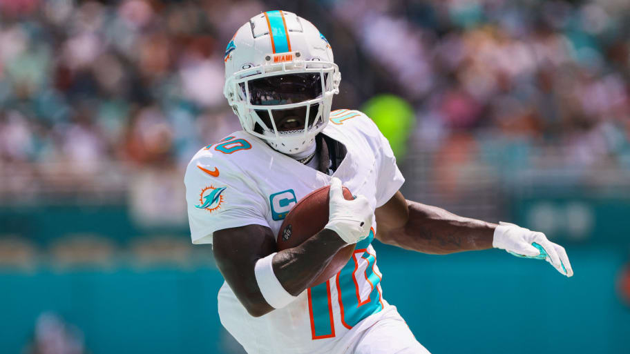 Miami Dolphins wide receiver Tyreek Hill (10) runs with the football against the Jacksonville Jaguars during the first quarter at Hard Rock Stadium.