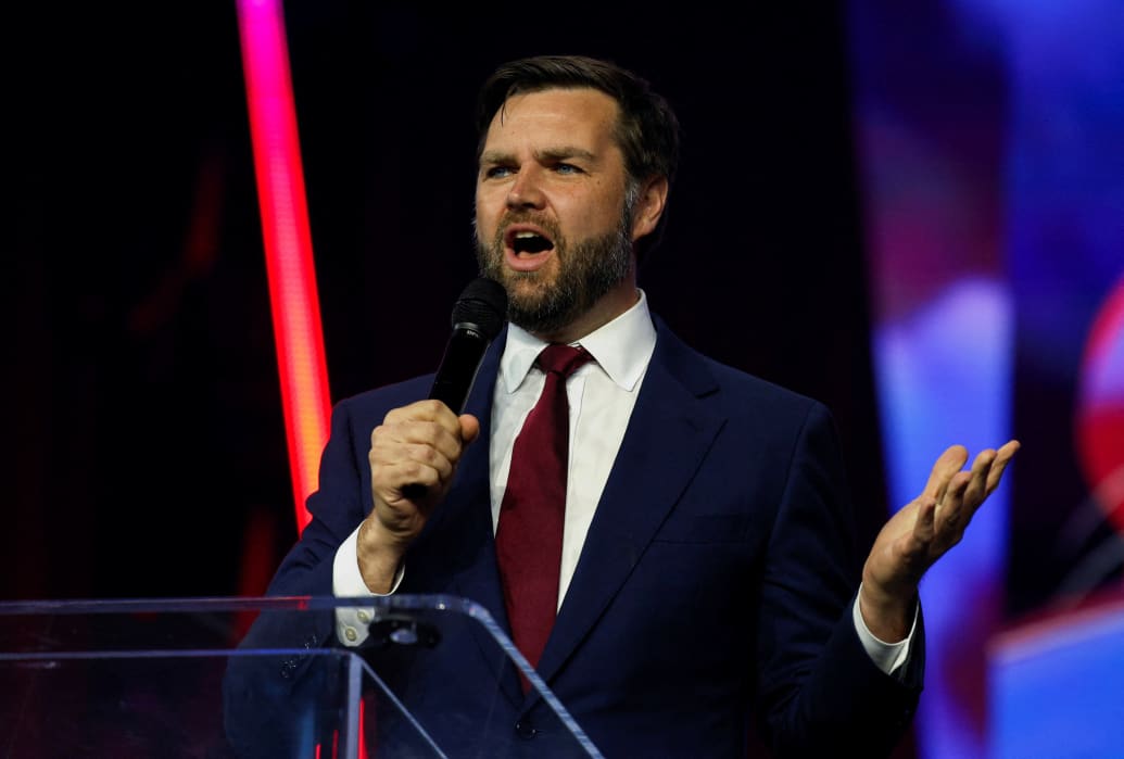 J.D. Vance, wearing a suit, speaks on stage.