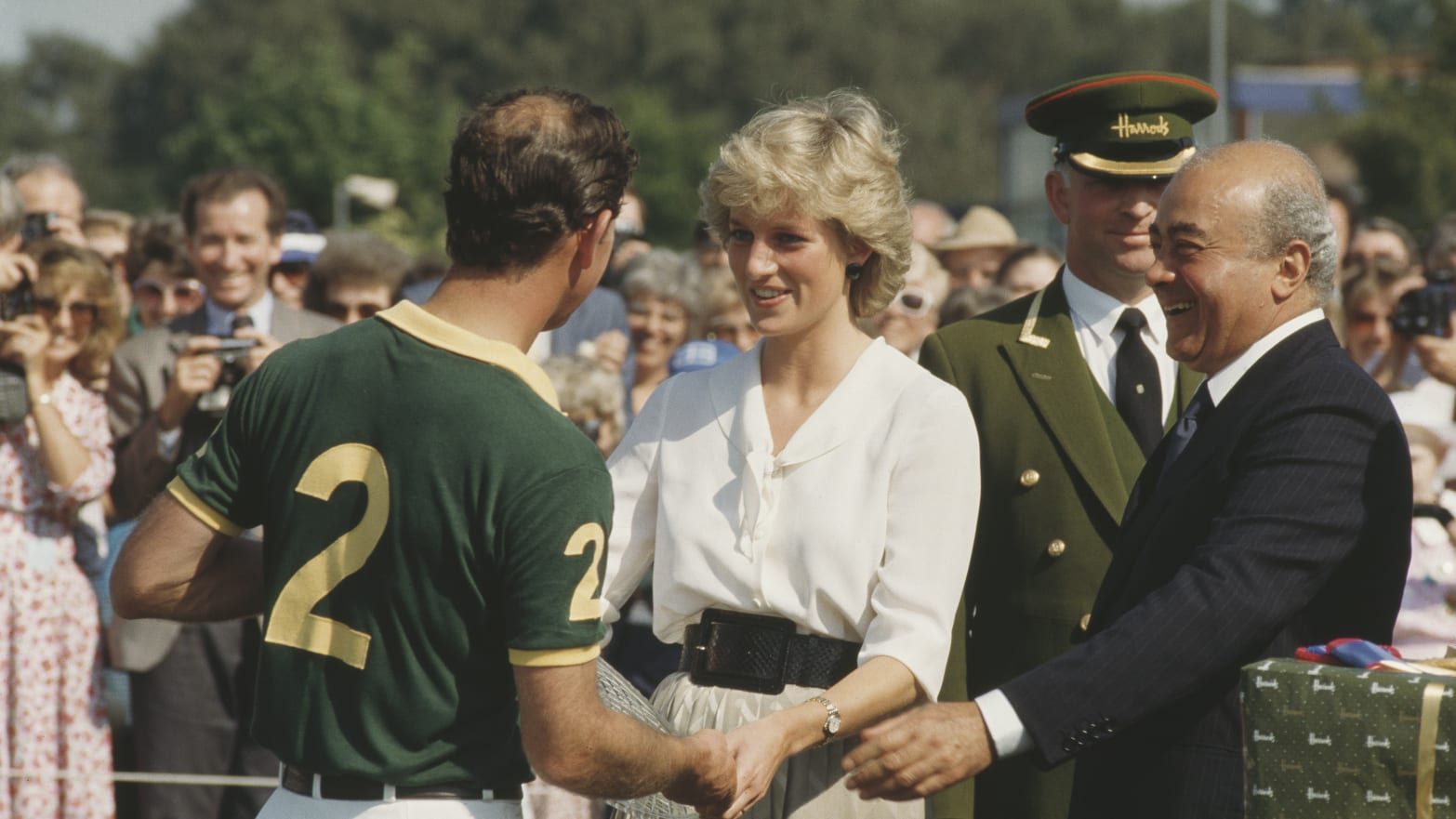 Princess Diana and Mohamed al-Fayed present a prize to Prince Charles at a polo competition in 1987