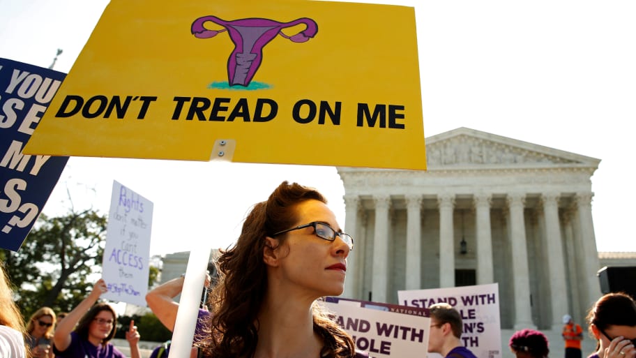 Demonstrators hold signs outside the U.S. Supreme Court as the court is due to issue its first major abortion ruling since 2007