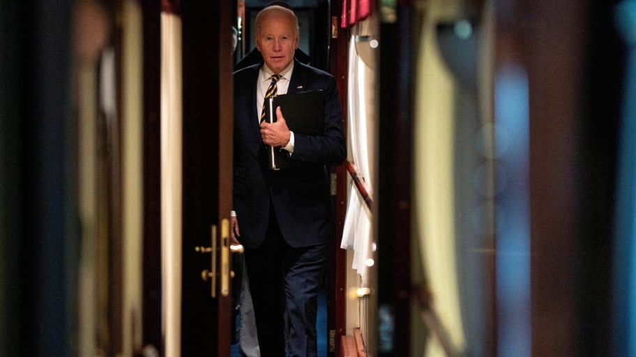 President Joe Biden walks down a corridor to his cabin on a train after a surprise visit with Ukrainian President Volodymyr Zelenskiy, Monday, Feb. 20, 2023, in Kyiv.