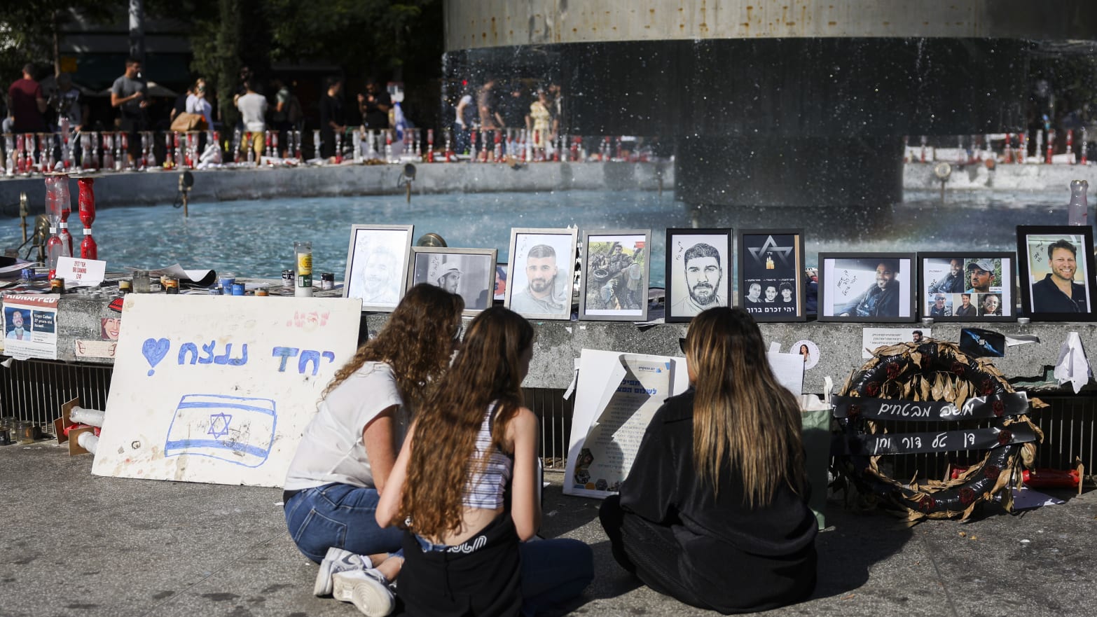 People walk by memorials to those kidnapped by Hamas in Dizengoff Square on November 24, 2023 in Tel Aviv, Israel.
