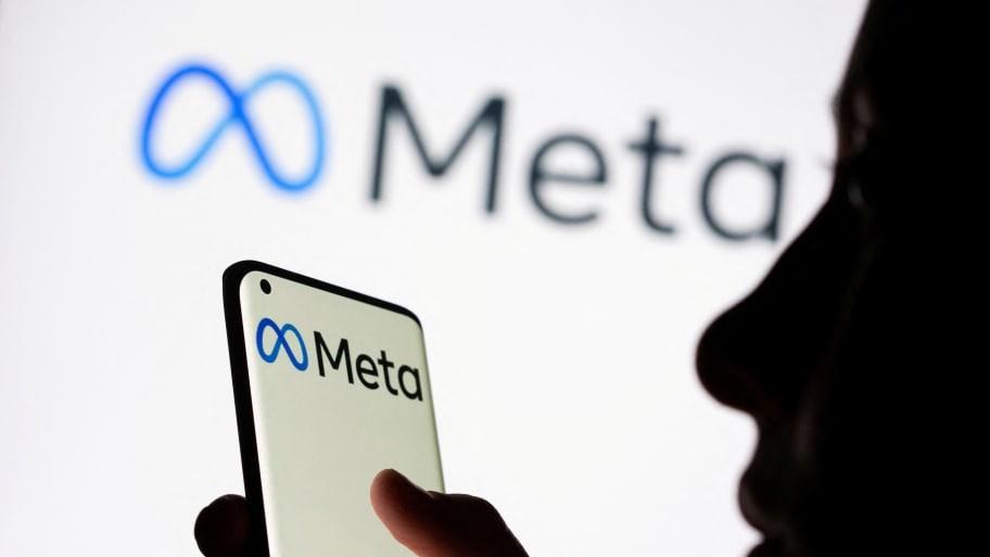A silhouette of a woman's face, holding a phone with a Meta logo, in front of a Meta logo