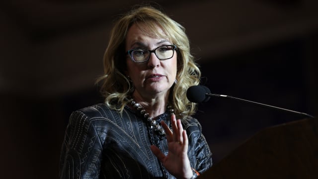 Gabby Giffords, former U.S. Representative and wife of Sen. Mark Kelly (D-AZ) introduces her husband at a campaign event at Cesar Chavez High School on Nov. 2, 2022, in Phoenix, Arizona. 
