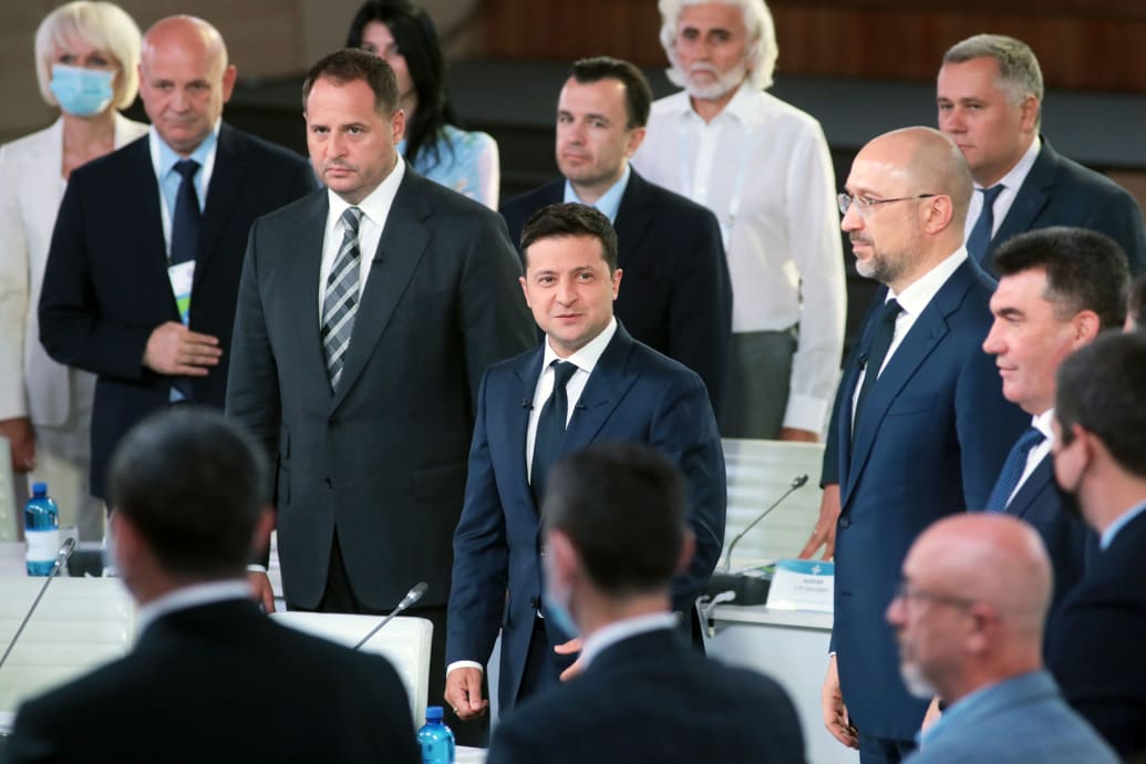 A photo of Ukrainian government officials surrounding President Zelensky.