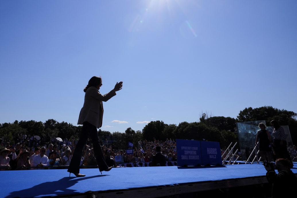 Democratic presidential nominee and U.S. Vice President Kamala Harris applauds as she attends a campaign stop in North Hampton, New Hampshire.