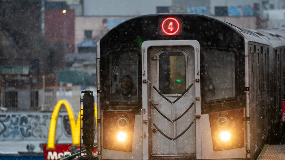 A 4 Subway train operates during snowfall in the Bronx borough of New York City.