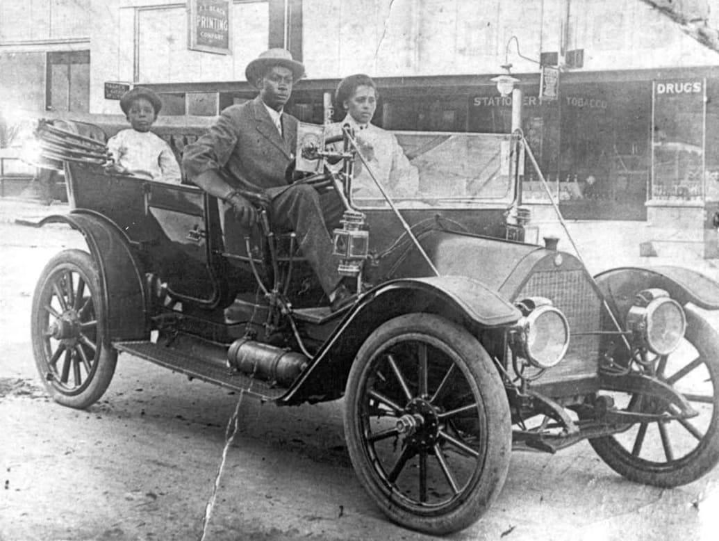 American businessman John Wesley Williams as he sits in his car with wife Loula Williams and their son, WD Williams, Tulsa, Oklahoma, 1910s.