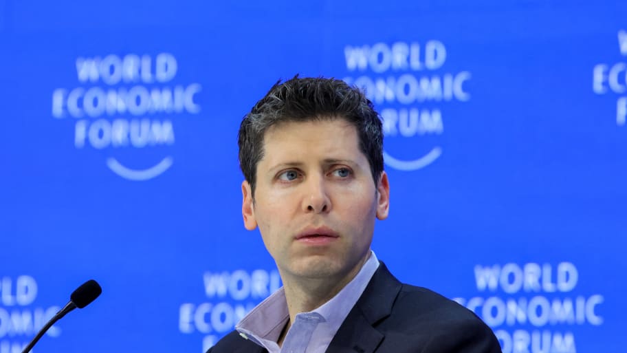 Sam Altman in front of a World Economic Forum sign