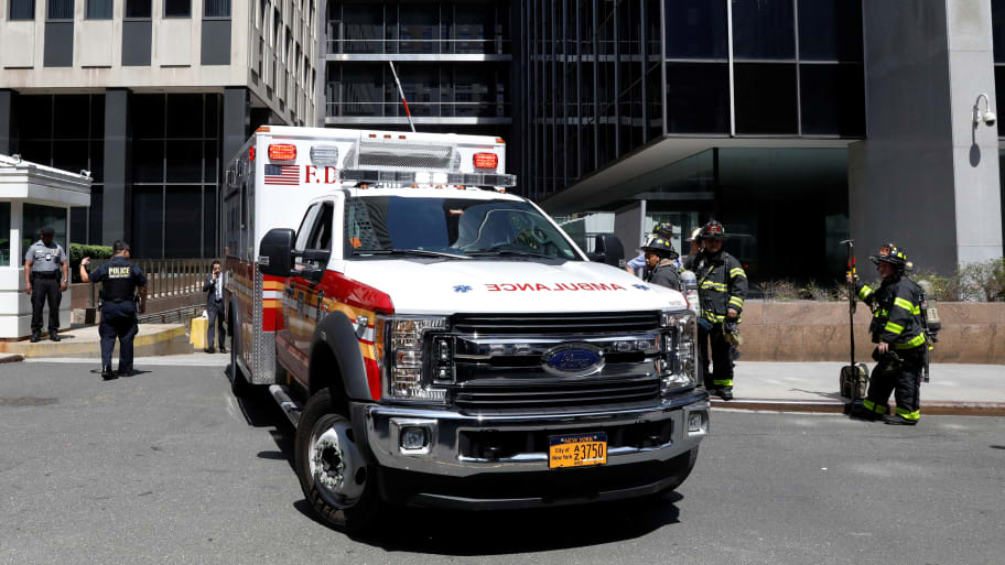 A New York City Fire Department (FDNY) Ambulance exits the the parking garage of 26 Federal Plaza, following an incident where an FBI Agent was injured.