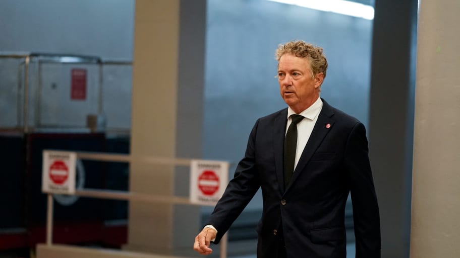 Rand Paul, dressed in suit, walks through Senate subway at the U.S. Capitol during a vote.