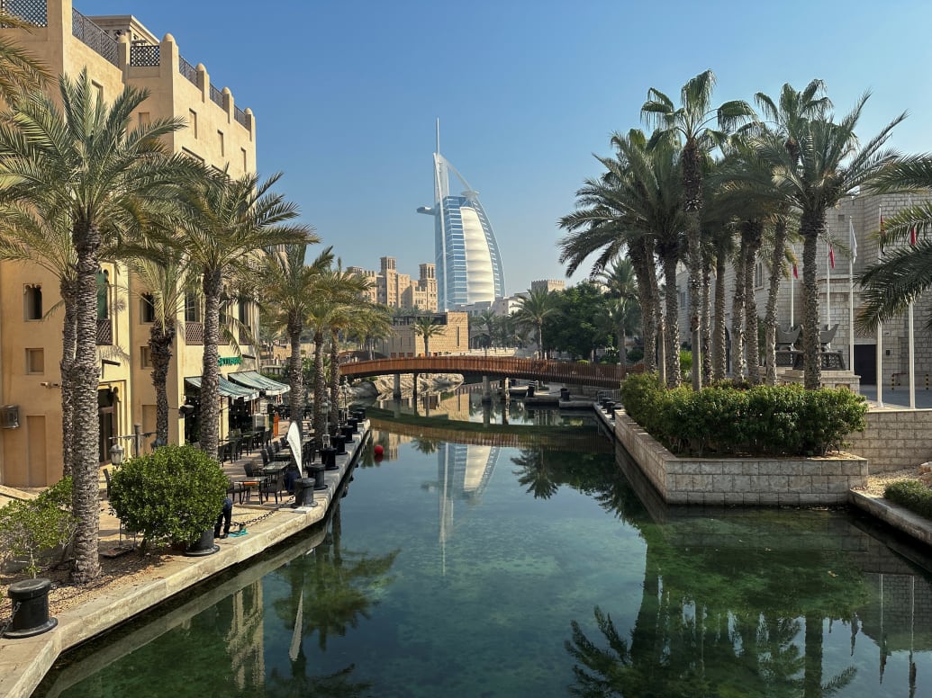 The Burj al Arab in Dubai seen through gardens and houses