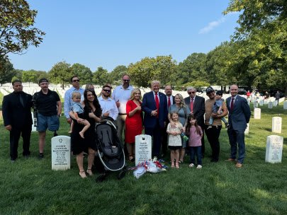 Donald Trump smiles with gold star families at Arlington National Cemetery.