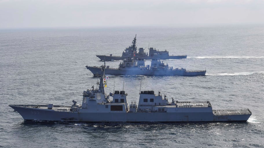 South Korean Navy's destroyer Yulgok Yi I, the US Navy's destroyer USS Benfold and Japan Maritime Self-Defense Force's destroyer Atago take part in joint naval missile defense exercises.