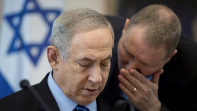 Boaz Stambler whispers to Netanyahu during the weekly cabinet meeting.