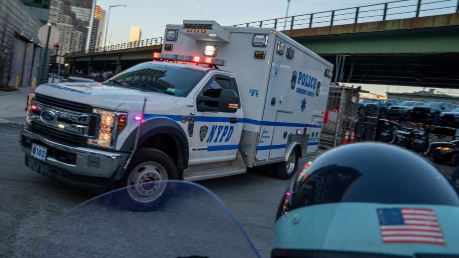 A vehicle of the New York City Police Department (NYPD) is seen as members of the New York City Police Department (not pictured) gather while the remains of officer Wilbert Mora is transported to the Medical Examiner