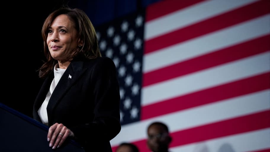Kamala Harris stands at a podium in front of a U.S. flag.