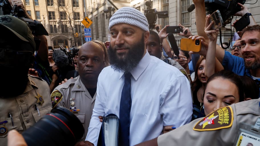 Adnan Syed leaves court after his conviction is overturned, surrounded by people taking photos