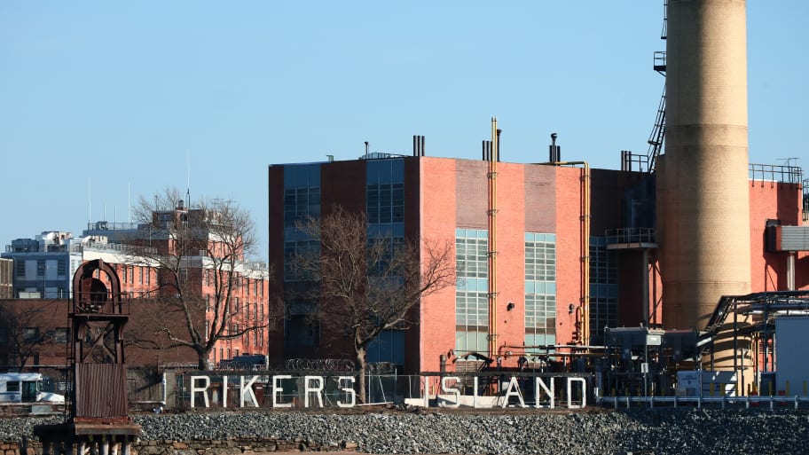 A sign marks the location of the Rikers Correctional Center in the East River