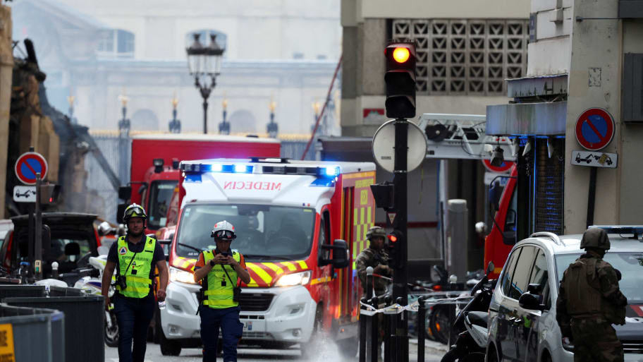 French rescue teams secure the area, after several buildings went on fire following a gas explosion in the fifth arrondissement of Paris.