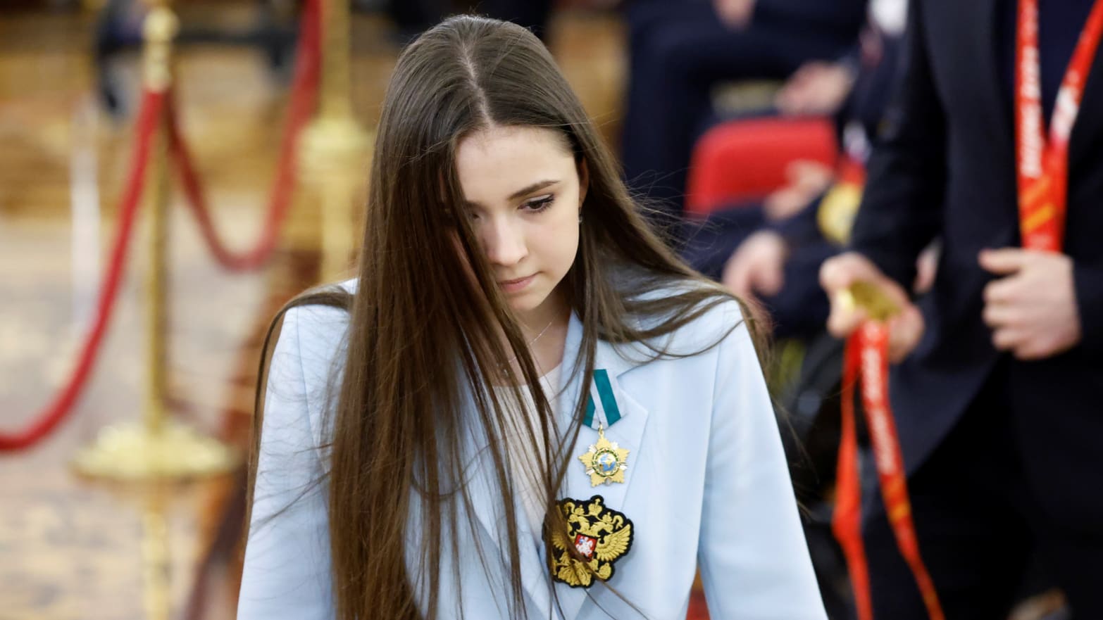 Kamila Valieva walks during a meeting with Vladimir Putin.