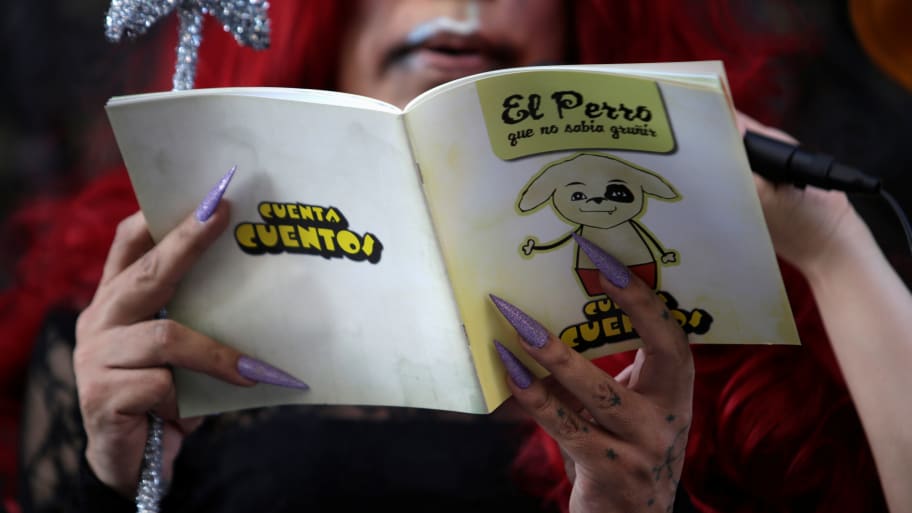 A participant dressed in drag reads a book during the "Drag Queen Story Hour" event, which according to organizers involves participants reading stories to children for an hour, in downtown Monterrey, Mexico June 9, 2019.