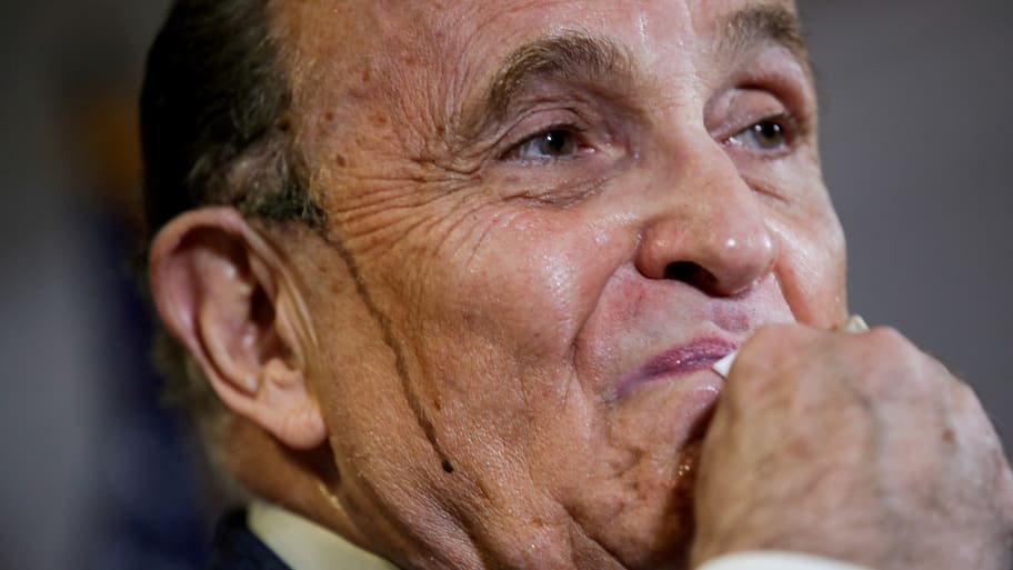 Rudy Giuliani, personal attorney to U.S. President Donald Trump, wipes away sweat as he speaks about the 2020 U.S. presidential election results during a news conference in Washington, U.S., November 19, 2020.