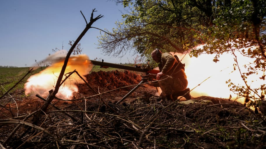 A Ukrainian service member fires an anti-tank grenade launcher at a front line near the city of Bakhmut, Ukraine, May 3, 2023. 