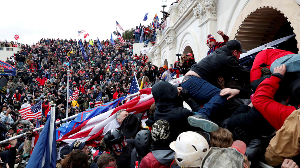 A horde of Donald Trump supporters clash with police as they try to storm the Capitol