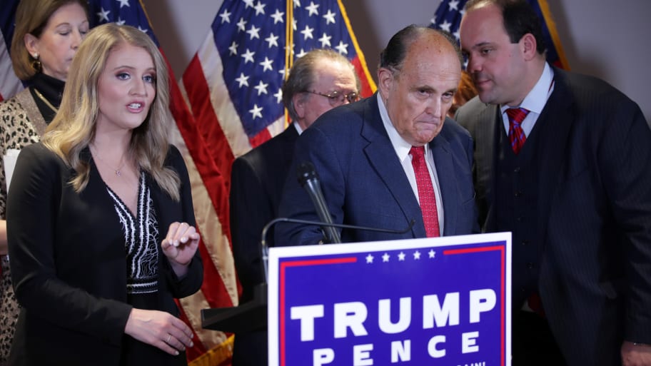 Trump Campaign senior legal adviser Jenna Ellis speaks as Trump campaign advisor Boris Epshteyn whispers to former New York City Mayor Rudy Giuliani in 2020.