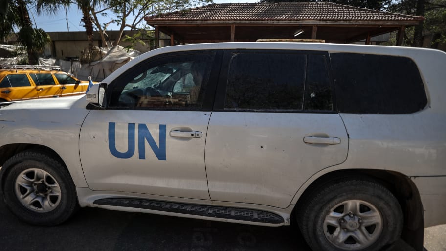 A view of a damaged UN vehicle in front of a hospital.