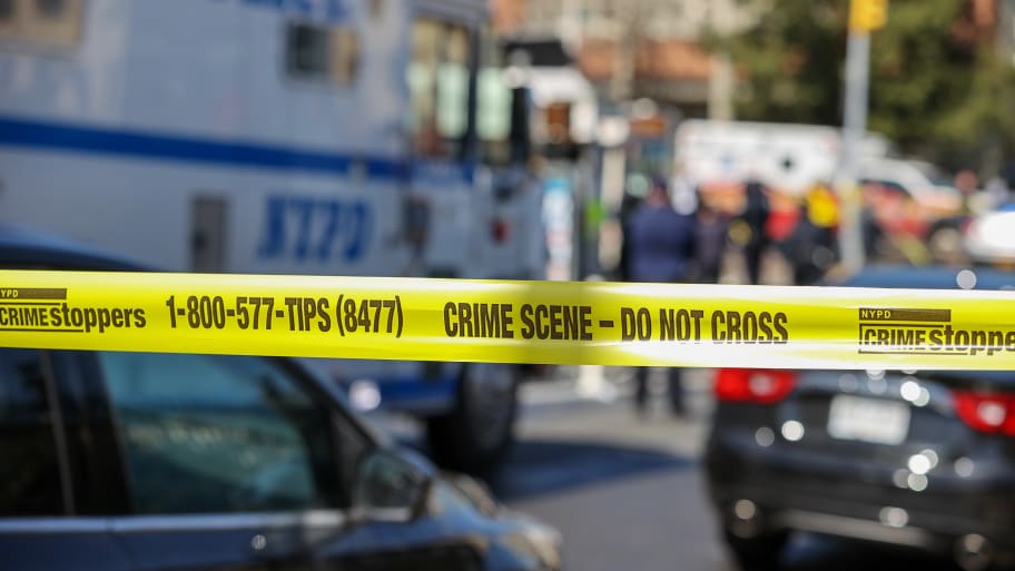 New York City Police Department members investigate the crime scene.