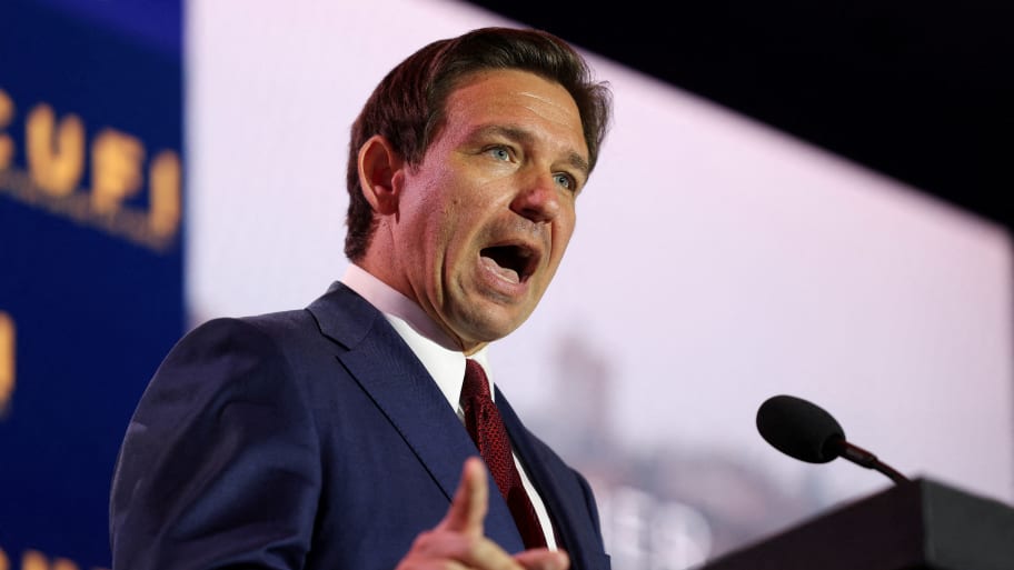 Presidential candidate Ron DeSantis speaks at a podium during a summit in July.